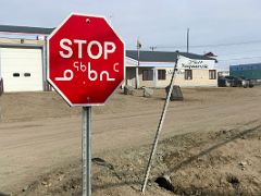 01C Stop Sign And Street Sign In Both English And Inuktitut In Pond Inlet Mittimatalik Baffin Island Nunavut Canada For Floe Edge Adventure